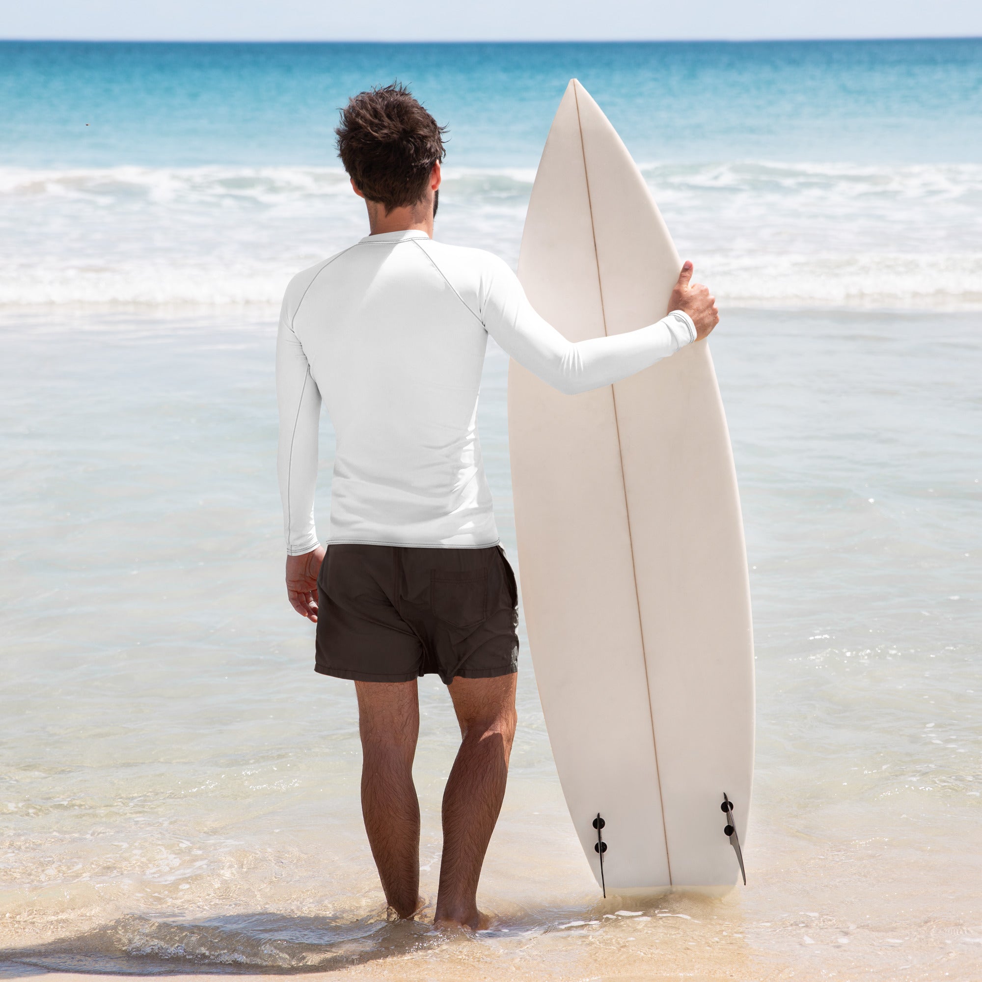Person holding a surfboard on a beach