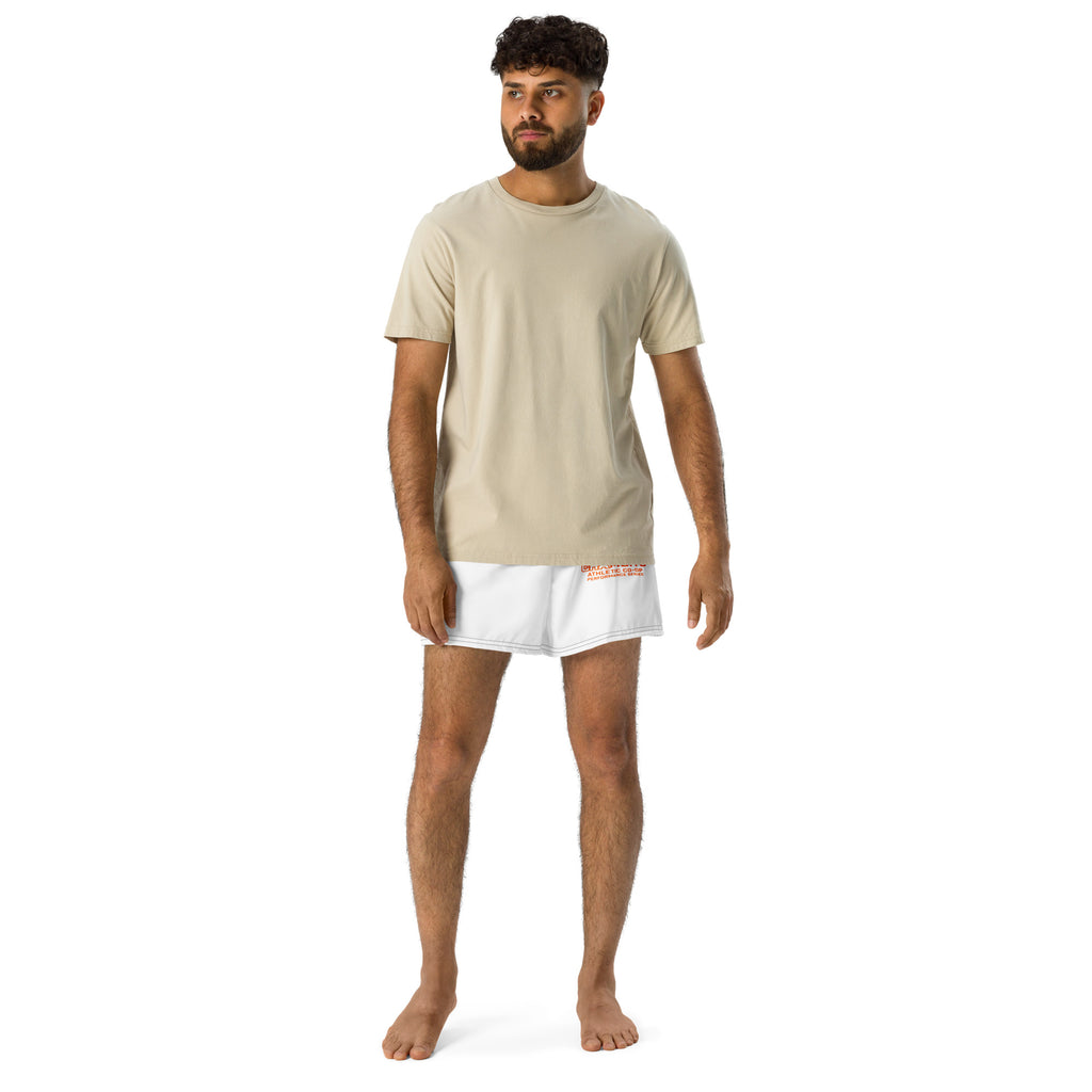 Man wearing a beige t-shirt and white shorts on a white background
