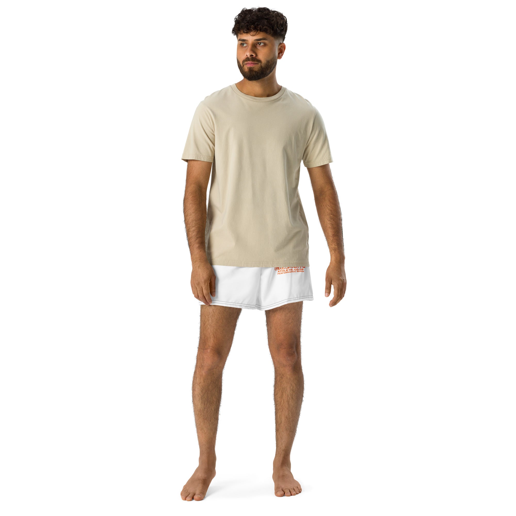 Man wearing a beige t-shirt and white shorts on a white background