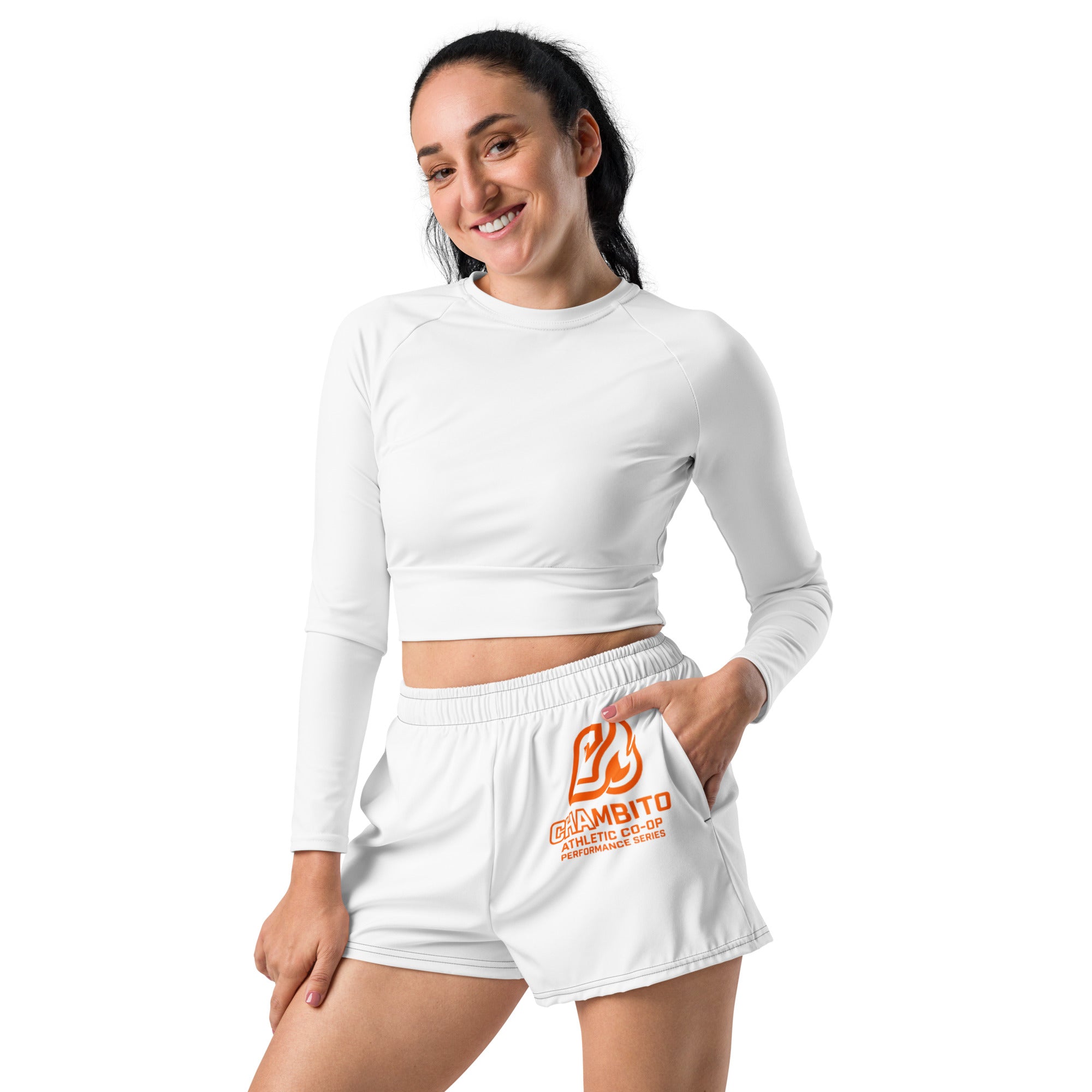 Woman wearing a white long-sleeve top and white shorts with a brand logo on a white background