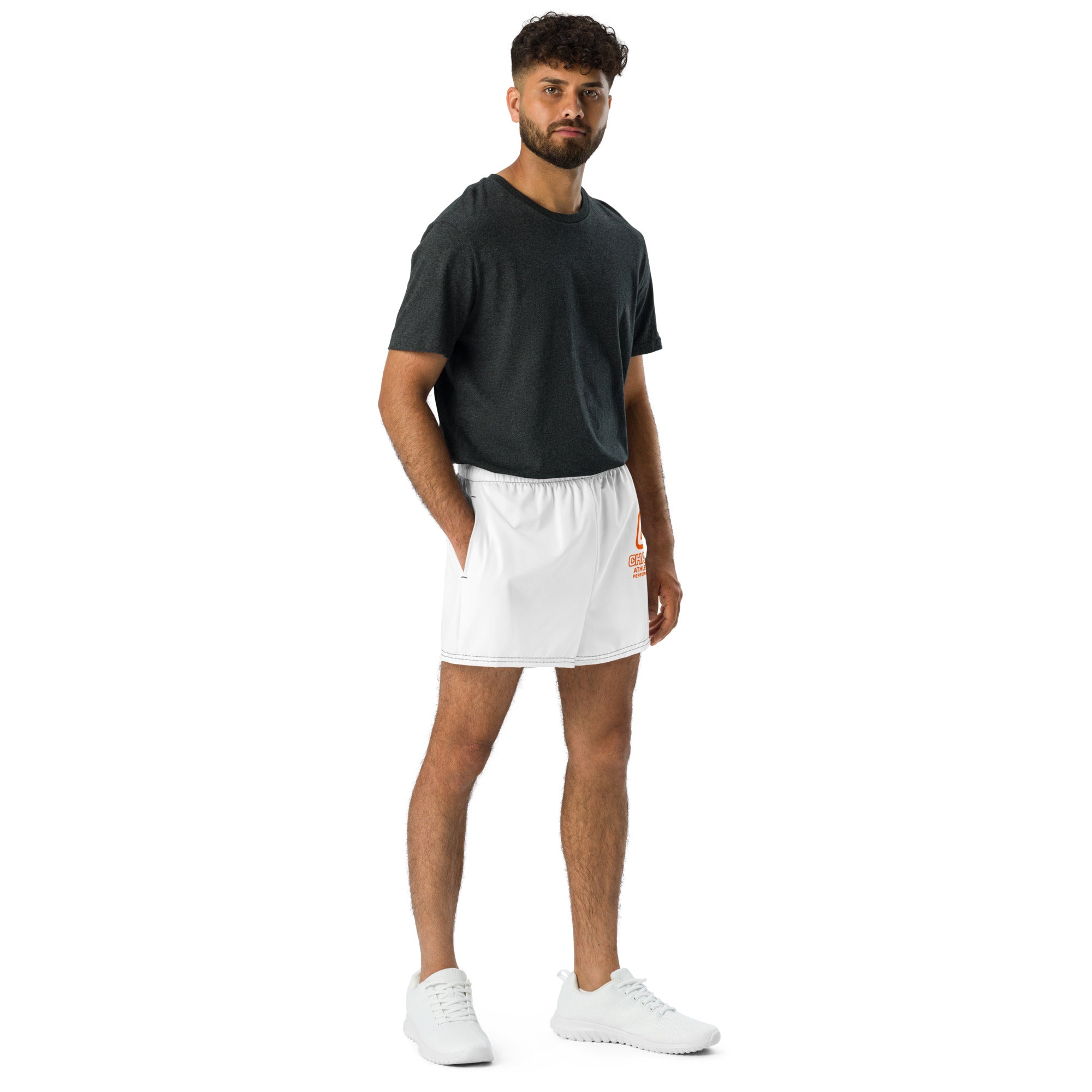 Man wearing a black t-shirt and white shorts on a white background