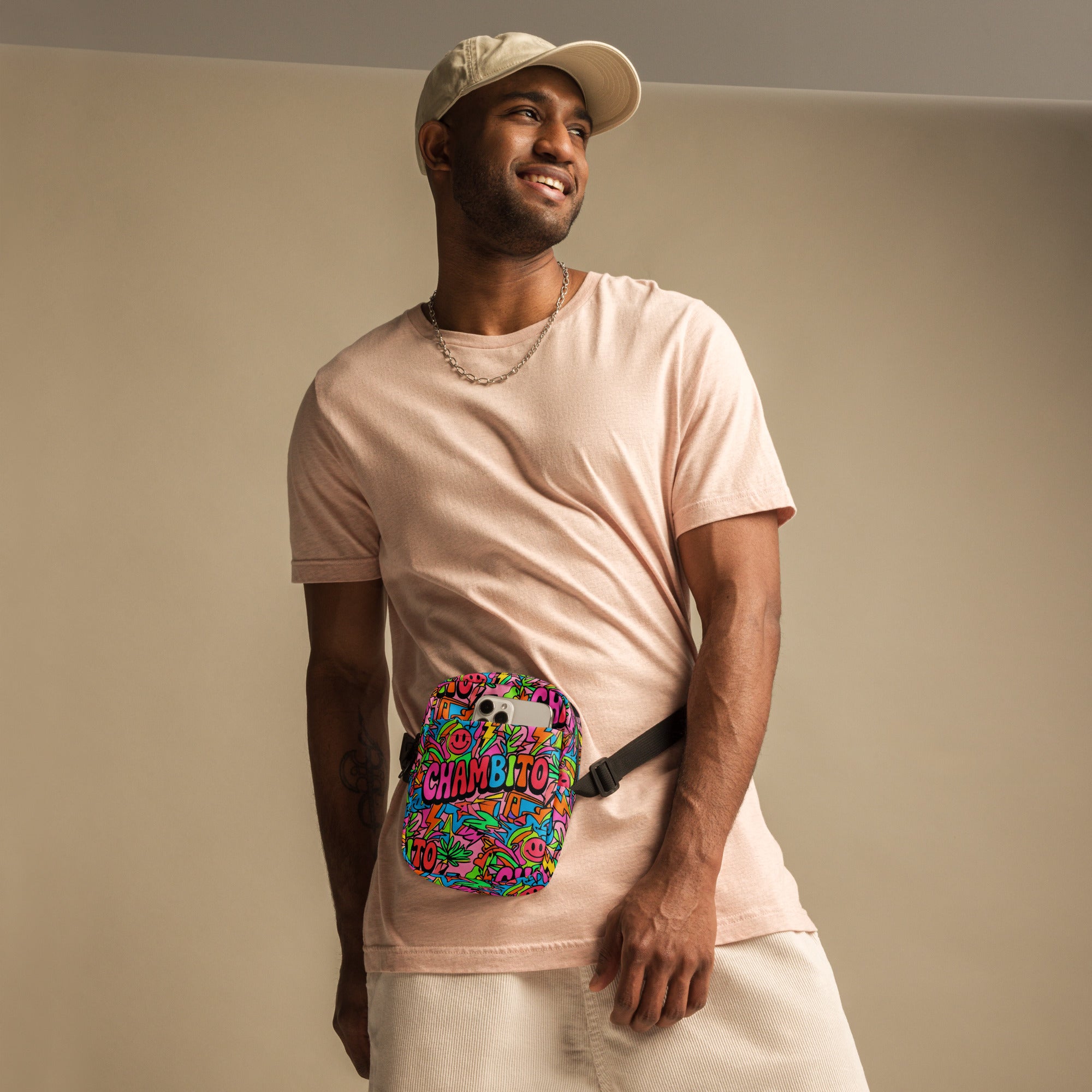 Man wearing a pink t-shirt with a graphic design, standing against a plain background