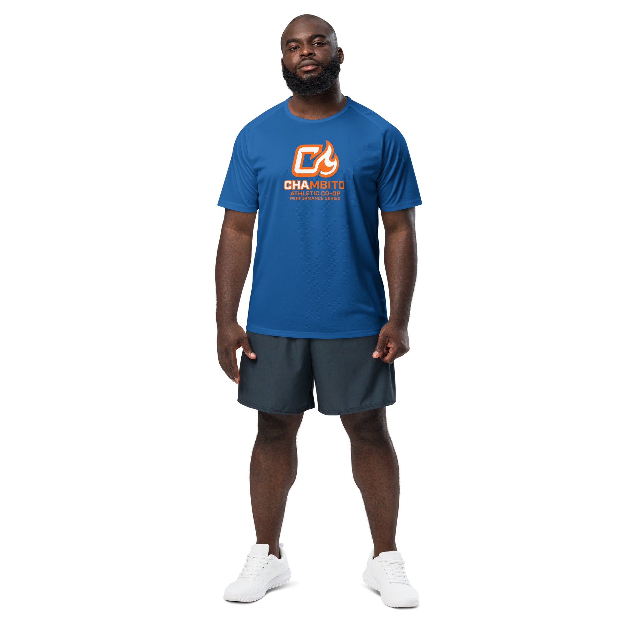 Man wearing a blue t-shirt with a logo and dark shorts on a white background